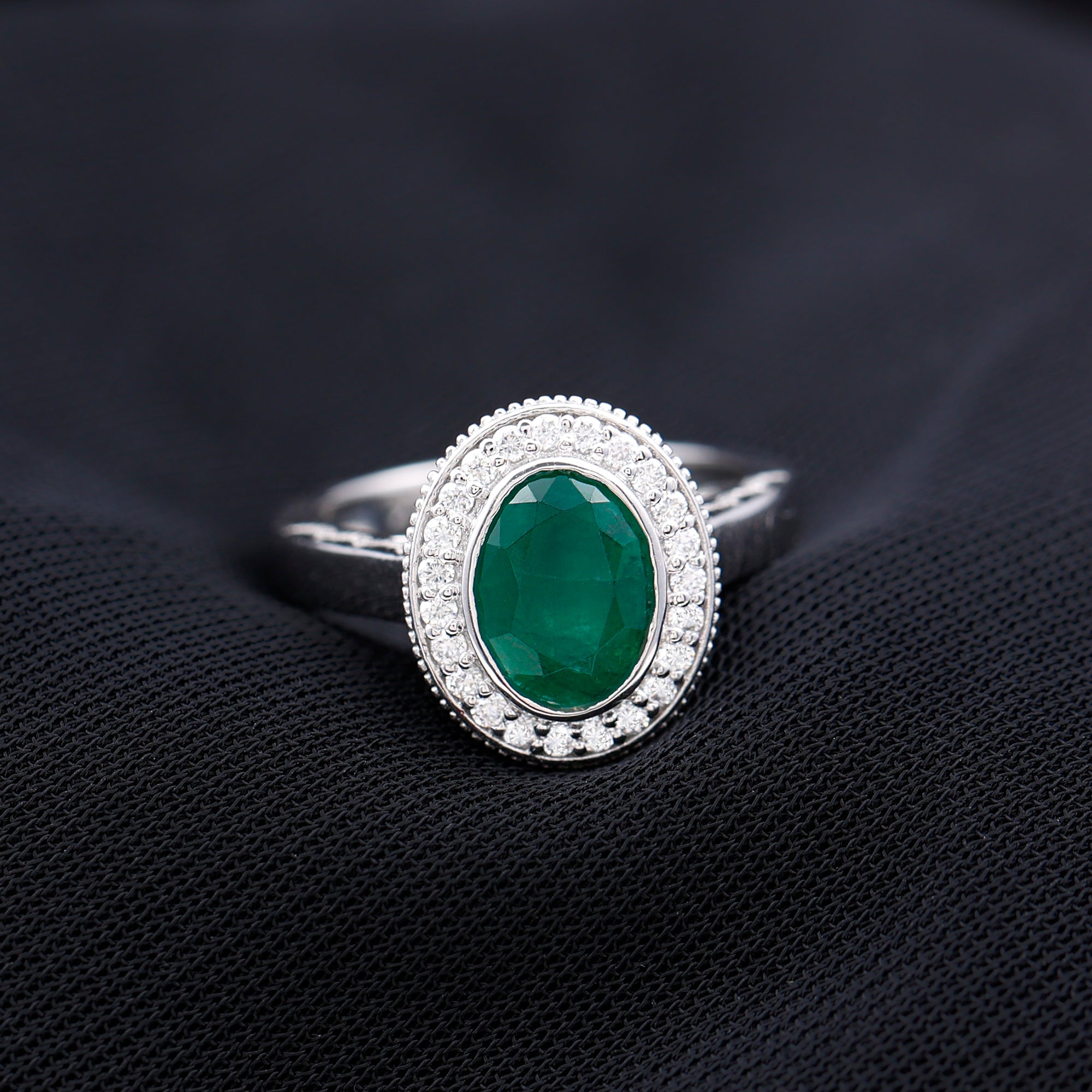 1.2 Carat Oval Lab Grown Emerald Bezel Set Engagement Ring With Diamond Halo