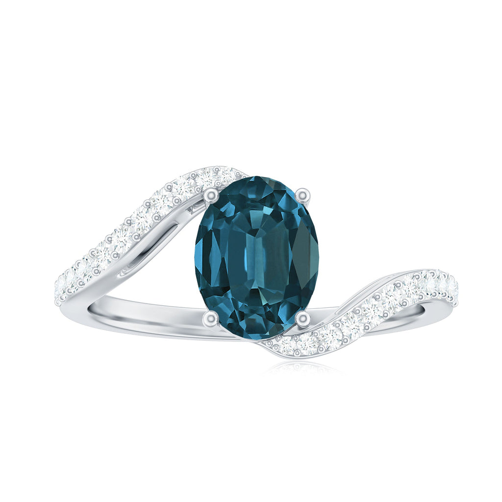 6X8mm Oval Cut London Blue Topaz and Diamond Bypass Engagement Ring