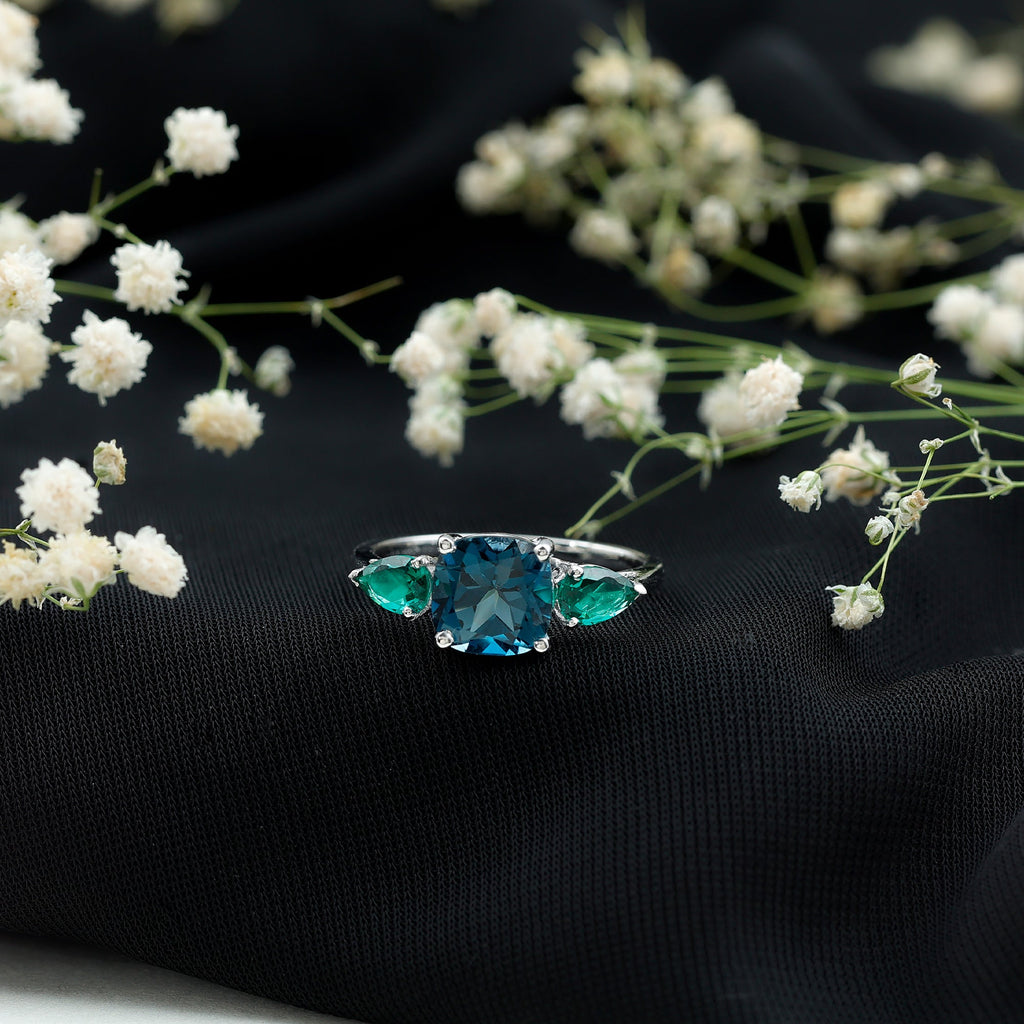 2.8 Carat Cushion Shape London Blue Topaz Three Stone Engagement Ring with Lab Emerald