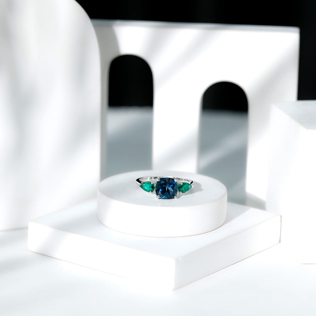 2.8 Carat Cushion Shape London Blue Topaz Three Stone Engagement Ring with Lab Emerald